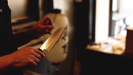 demonstrating knife sharpness by slicing through paper