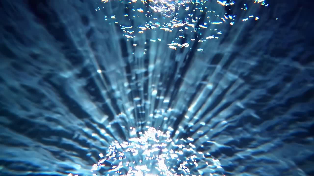 Underwater video capturing sunlight rays through water, creating a mesmerizing pattern