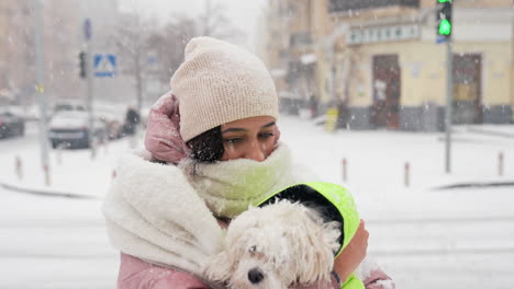 woman and dog in snowy city