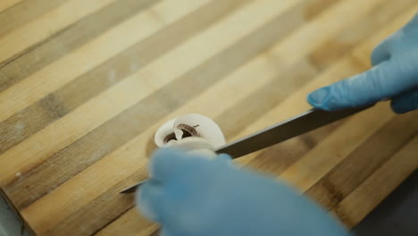 chef hands cutting mushrooms