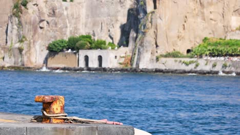 rusty bollard against scenic coastal backdrop