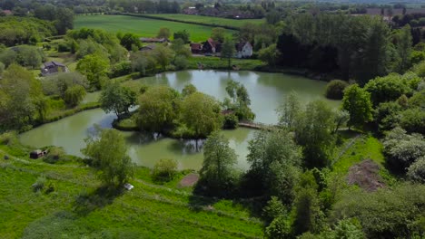 Aerial-rotating-shot-of-Weybread-lake-in-Waveney-Valley