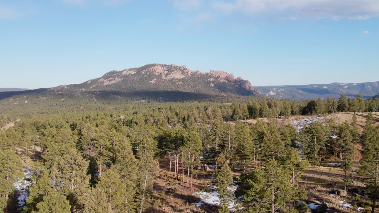 Aerial drone view of the Pike National Forest and Long Scraggy Mountain. Trucking movement to the left. Filmed in the Rocky Mountains of Colorado.