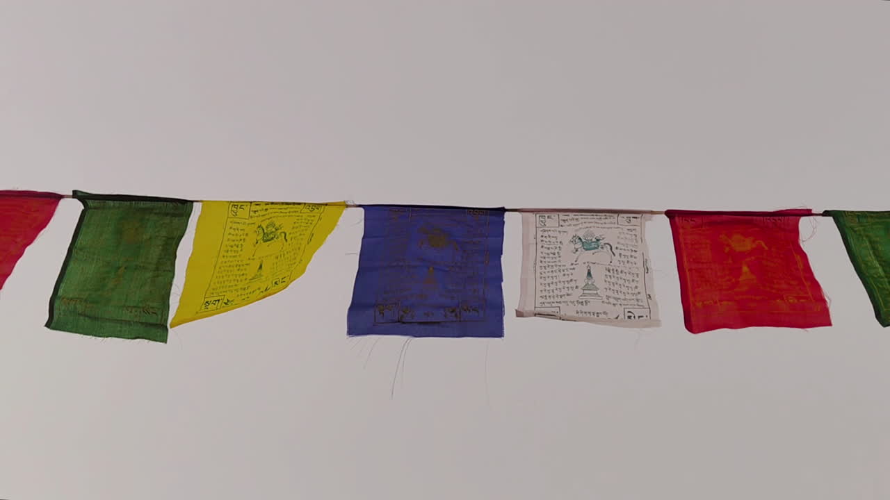 Himalayas prayer flags flutter in wind. Buddhist Lungta banners blowing on mountain pass, symbolizing peace, wisdom, compassion. High altitude travel, culture, religion footage