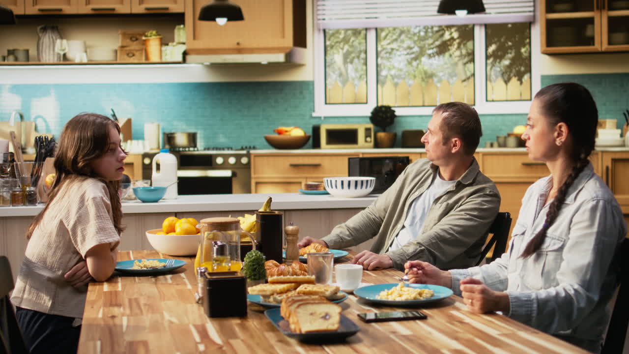 Father feeling agitated and concerned about his daughter at breakfast