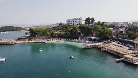 Bird's-eye-view-of-picturesque-Ksamil-village-on-Albanian-Riviera's-Ionian-Sea-coast-on-a-sunny-day