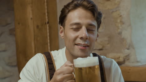 man in lederhosen drinking beer