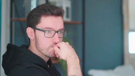 young man thinking, hand on chin, thinking pose