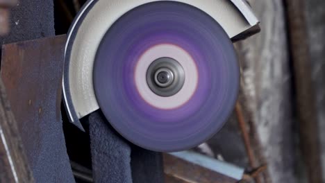 a worker cuts metal pipe with a grinder close-up. a lot of sparks.