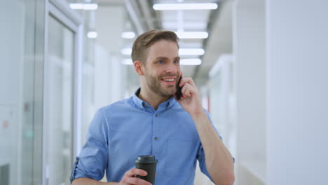 cheerful man talking phone in office. joyful business man smiling colleague