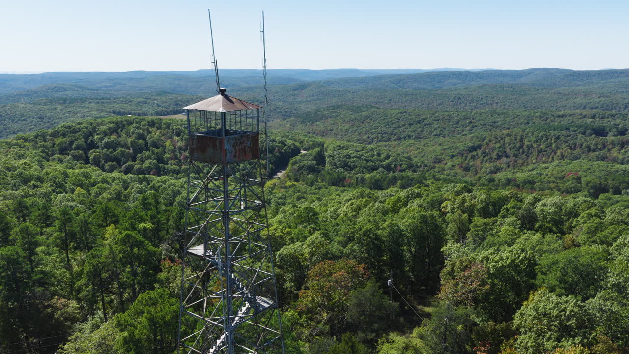 Green Forests Surrounding Devil's Knob Lookout Tower In Arkansas, USA - Aerial Shot
