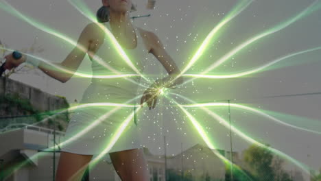 Female tennis player gripping racket on court, ribbons illustrating technology data flow
