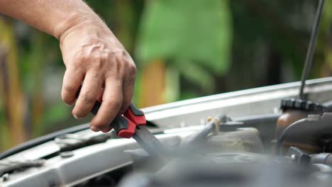 person repairing a car engine.