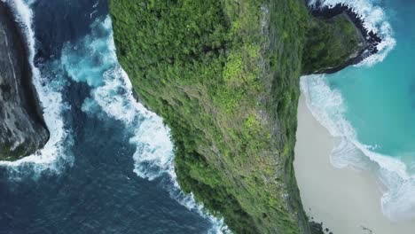 Dramatic-aerial-view-directly-above-Kelingking-Beach-and-mountain-in-Bali