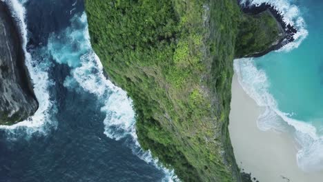 dramatic aerial view directly above kelingking beach and mountain in bali