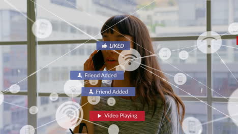 animation of network of connections with media icons over biracial woman using smartphone
