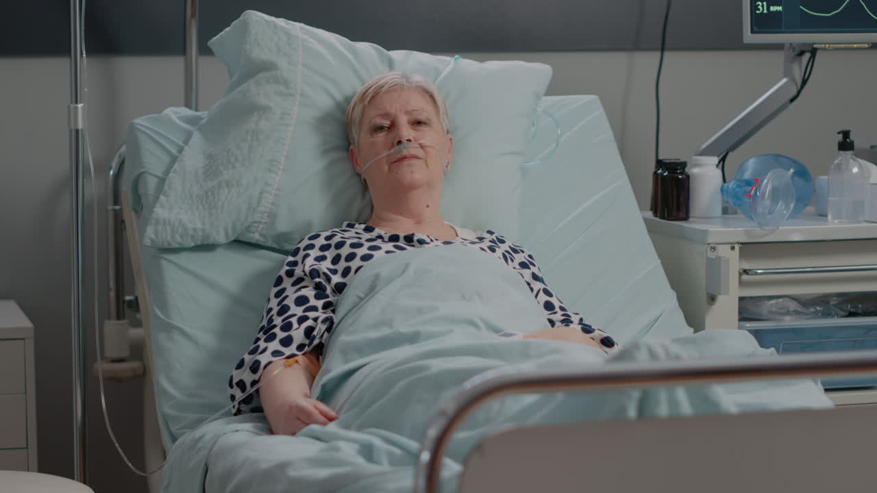 Portrait of sick patient laying in hospital ward bed
