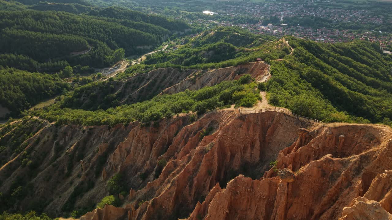 Cinematic aerial of the Stob Pyramids Bulgaria sandstone formations framed by hills forests and valleys