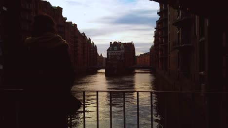 slow-motion poggenmühlenbrücke (hamburg). the water castle in the old warehouse district of hamburg during daylight. hafencity.