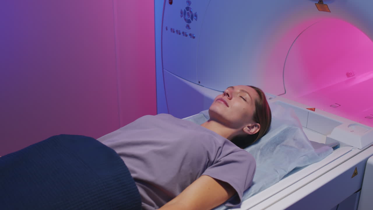 Young Woman Lying on Scanner Table for MRI