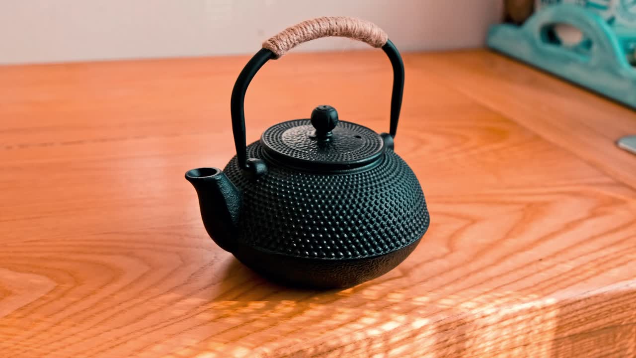 Asian style, textured, cast iron tea pot on a counter