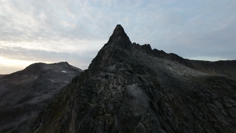 Ascending-along-a-ridge-up-to-Djeveltanna,-revealing-a-magical-sunset