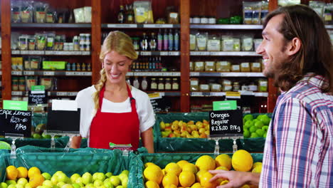 smiling staff assisting a man with grocery shopping