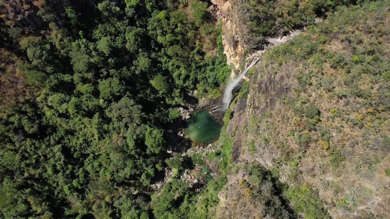 aerial view of Catoá waterfall, large waterfall in Paranã Tocantins and Chapada dos Veadeiros Goias, drone of Brazilian landscape, sunny day, trees, crystal clear and green water