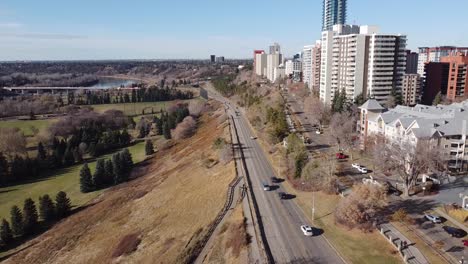 aerial fly over drop by rivers edge vip golf course park in the fall edged with high rise condomiums apartments and commercial building by roadside access to the freeway highway groat bridge park 3-3