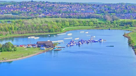 orbit drone shot of aquatic fun park on the lake during the day in rother valley country park in the metropolitan borough of rotherham, south yorkshire, england