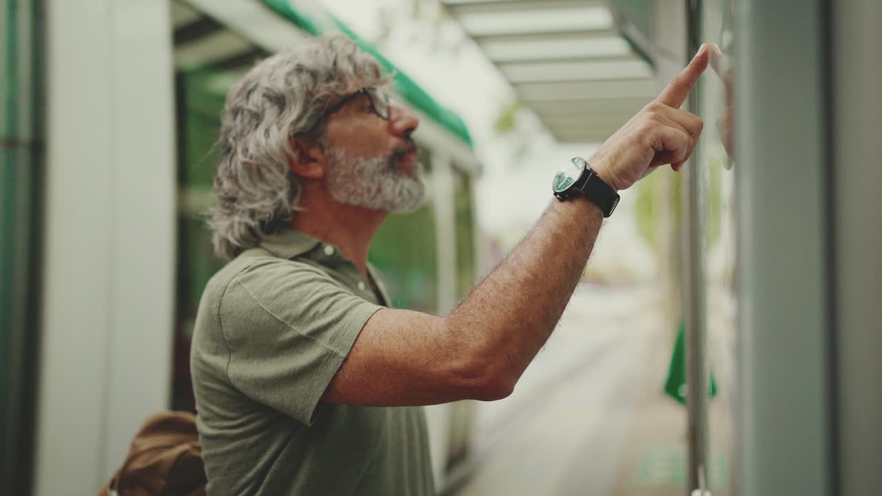 Man checking bus schedule at bus stop