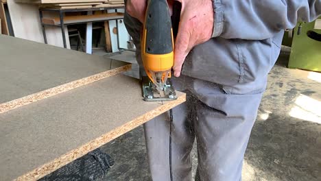 cortando un tablón de madera con una sierra manual en cámara súper lenta
