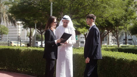 three people talking about business