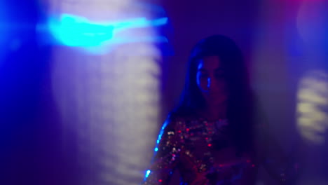 Close-Up-Of-Woman-In-Nightclub-Bar-Or-Disco-Dancing-With-Sparkling-Lights