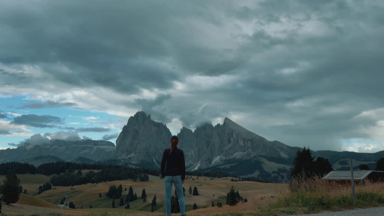 Tourist enjoying Alpe di Siusi mountain landscape in Dolomites, Italy, slow motion