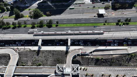 aerial view of city traffic with train and highway