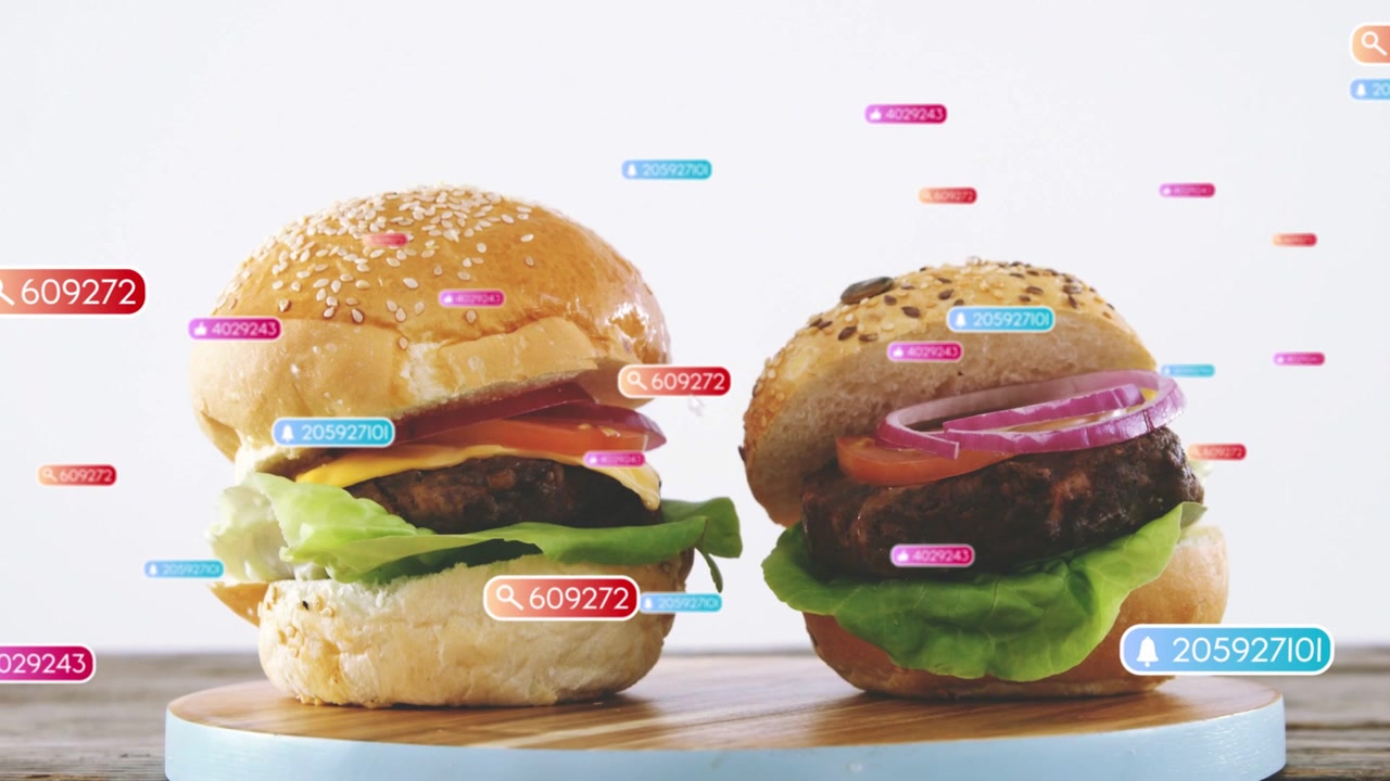Data badges appearing, drifting, causing two burgers revealing layers, labeling parts for marketing