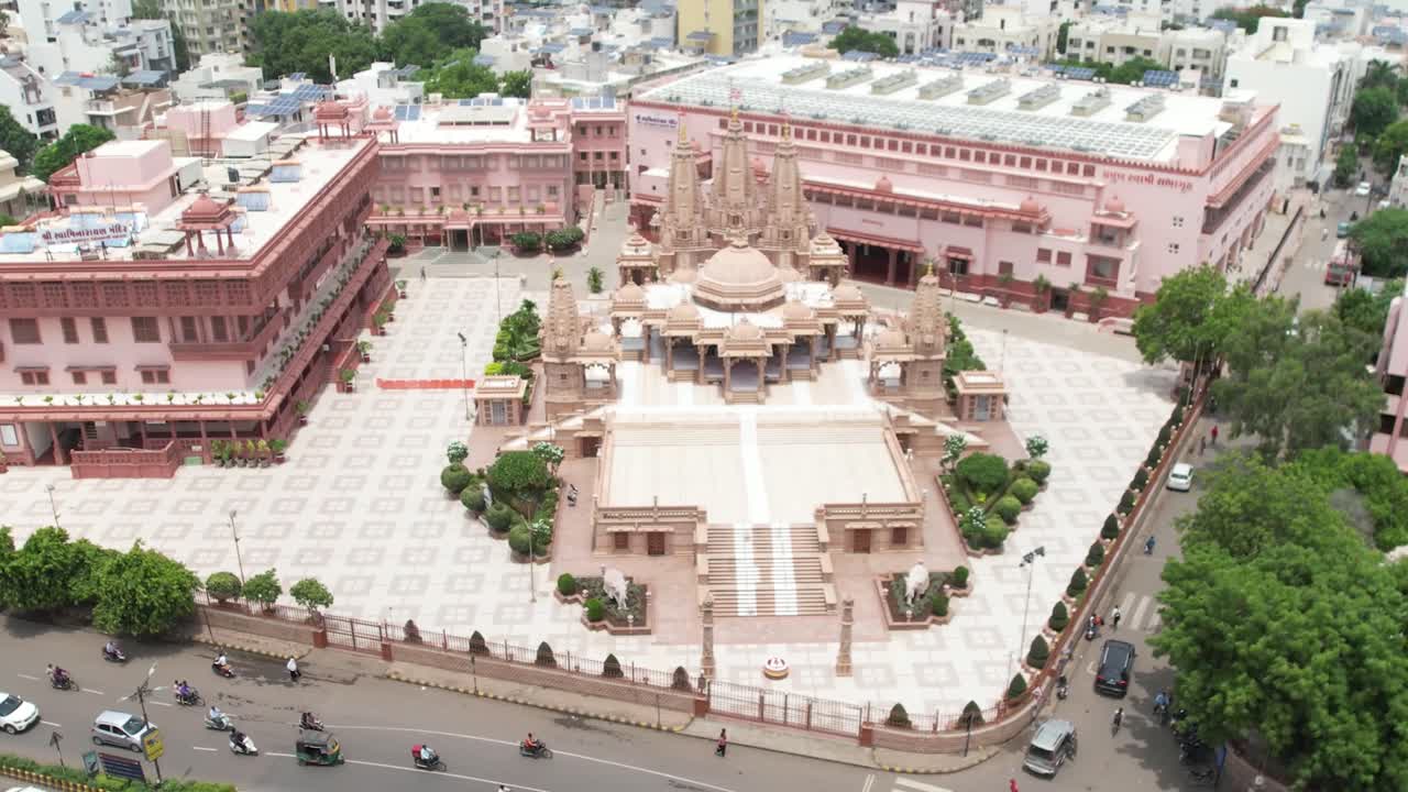 A large Swaminarayan temple is visible