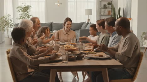 a multi-generational diverse family enjoying a meal together