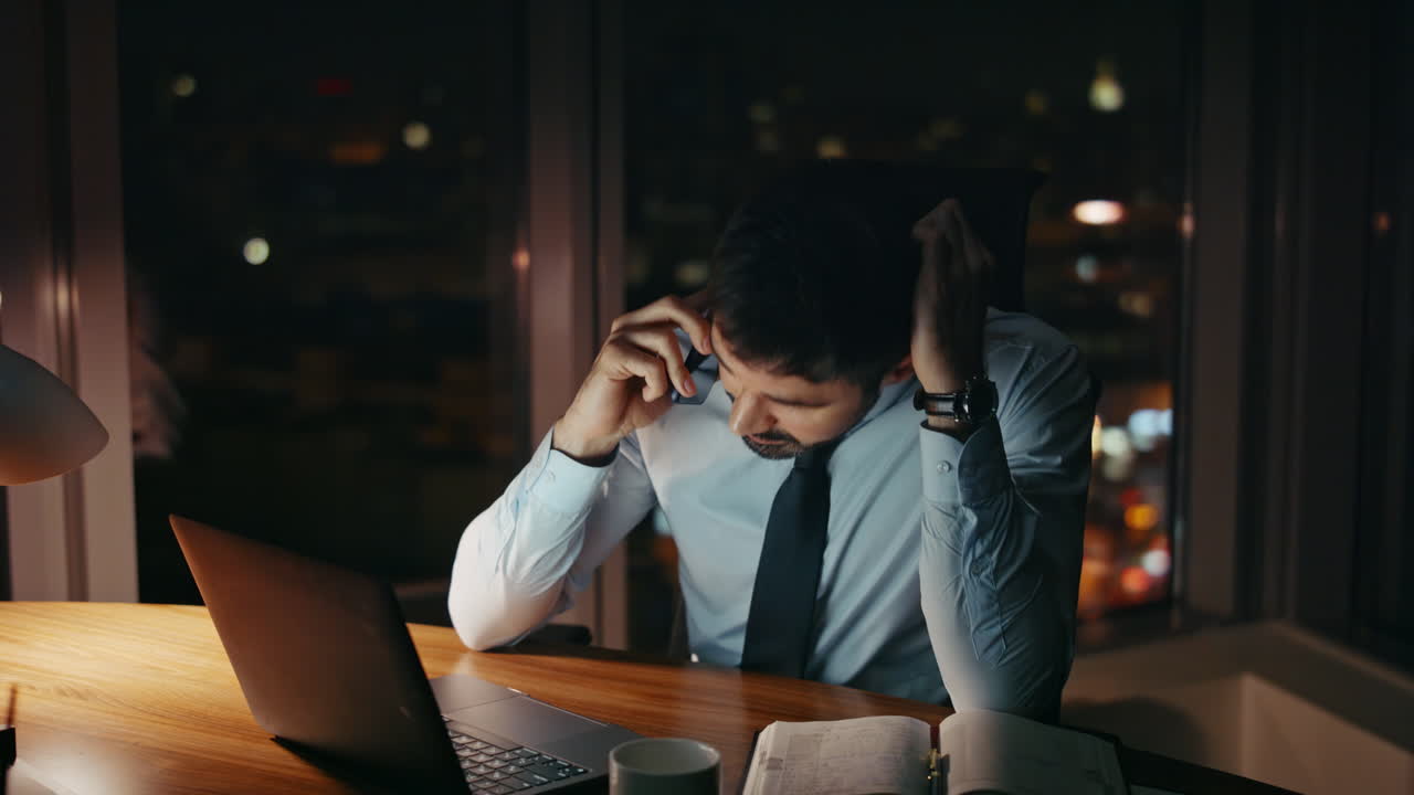 Worried manager calling emotionally talking at office desk close up. Ceo problem