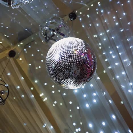 a ceiling adorned with disco balls and festive lights