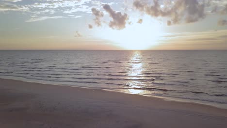 beautiful aerial establishing view of baltic sea coast on a sunny evening, sunset, golden hour, beach with white sand, coastal erosion, climate changes, wide angle drone shot moving forward