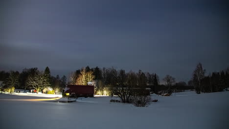 Time-lapse-shot-of-dark-clouds-covering-sky-during-snowy-winter-day-with-apartments-in-rural-area