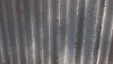 sunlight patterns changing on textured metal surface