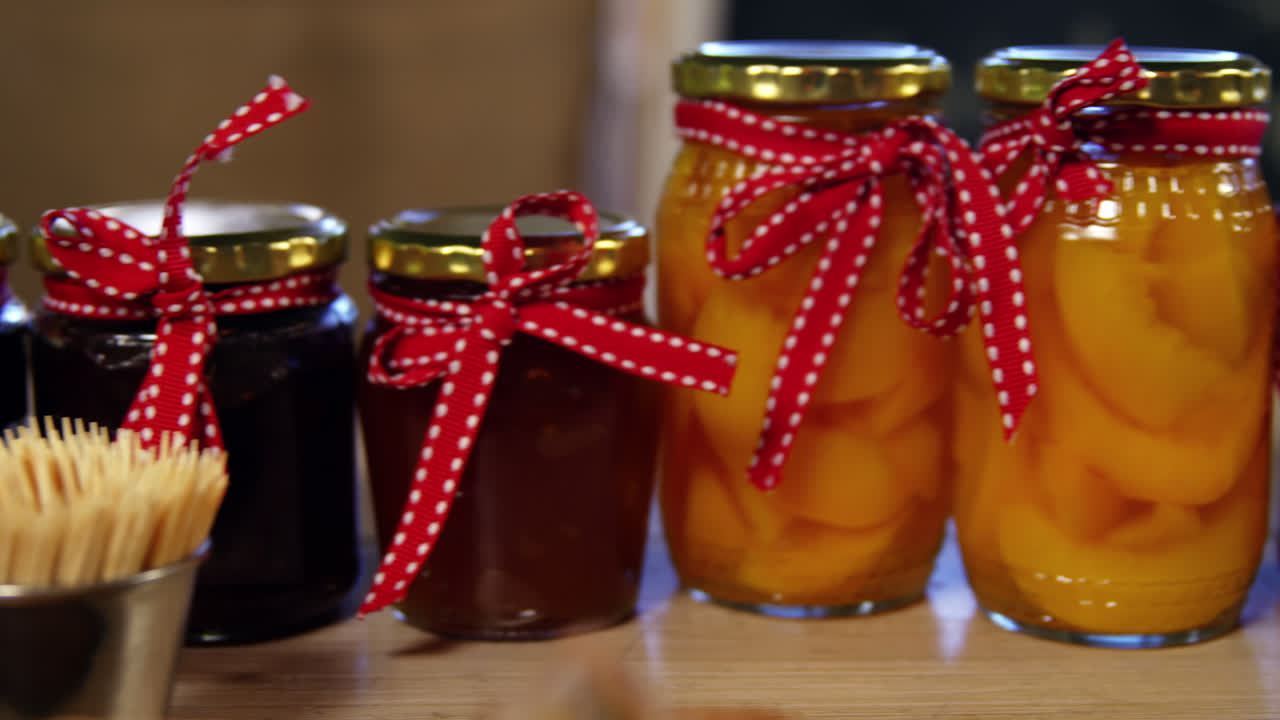 Jars of pestos, jam and preserves on display counter