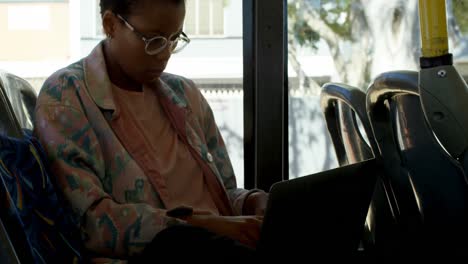 Female-commuter-using-laptop-while-travelling-in-bus-4k