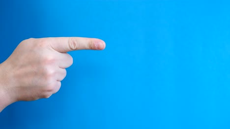 man pointing finger away on chroma key background with blue background man pointing finger away on chroma key background with blue background slow motion