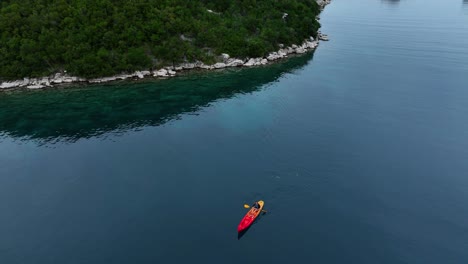 aerial view of a persona canoeing alone on a beautiful river.