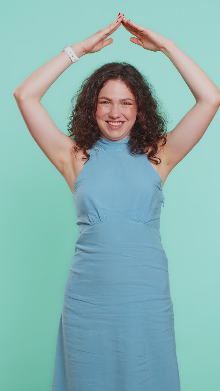 Woman feeling in safe making roof above head with hands insurance security service playing game