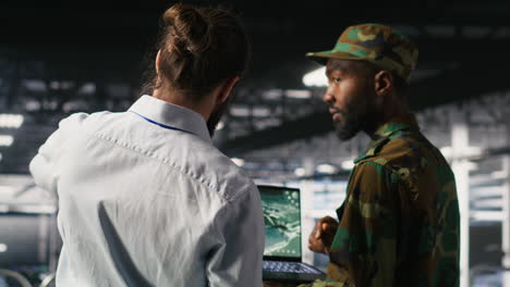 military server hub technician reviewing tactical dashboard on laptop